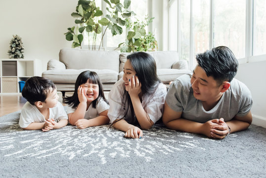 Asian family playing in the living room
