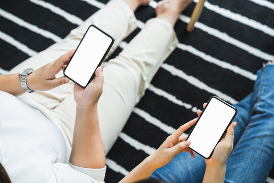 Woman hand holding smartphone and touching blank screen. Mockup of advertisement.