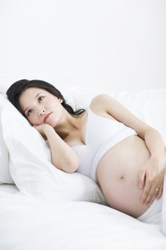 Pregnant woman lying in bed