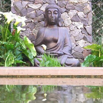 宁静花园中的佛像倒映在小水池里