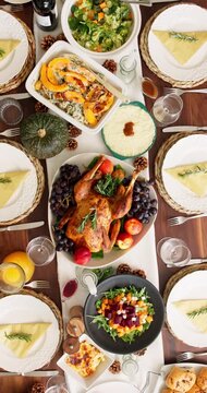 Thanksgiving, above and food or turkey on table in dining room for festive holiday, feast decoration and meal. Culture, season and roast dinner with chicken and spread in home for event and dishes
